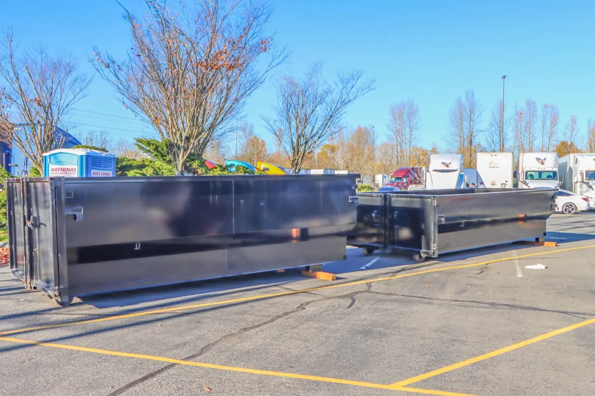 Professional dumpster rental service with roll-off container on residential driveway in Emporia